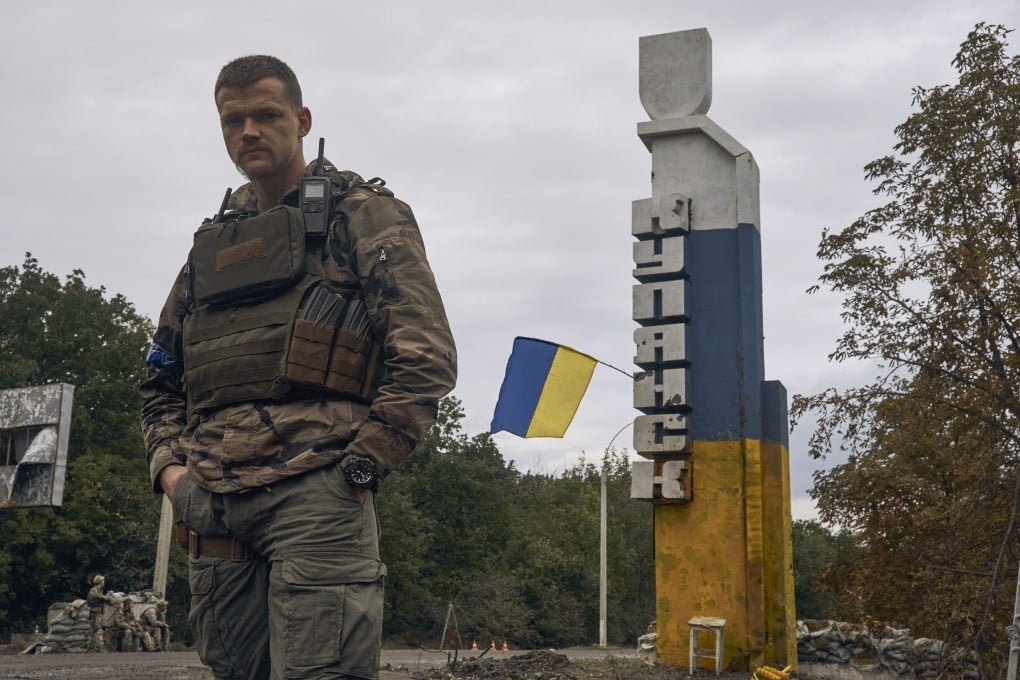 A Ukrainian soldier stands near the sign reading “Kupiansk” in the recently retaken Kupiansk in the Kharkiv region on September 14. Ukrainian troops piled pressure on retreating Russian forces pressing deeper into occupied territory and sending more Kremlin troops fleeing ahead of the counteroffensive that has inflicted a stunning blow on Moscow’s military prestige. Photo: AP