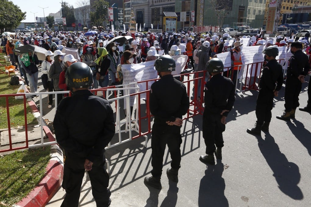 Drones buzzed low overhead and surveillance cameras kept watch as thousands of Cambodian workers protested near Nagaworld Casino in Phnom Penh. Photo: EPA-EFE