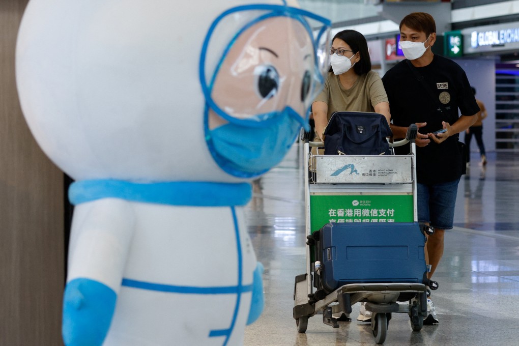 Travellers walk past an installation featuring a medical worker at the Hong Kong International Airport’s departure hall on August 1. Photo: Reuters