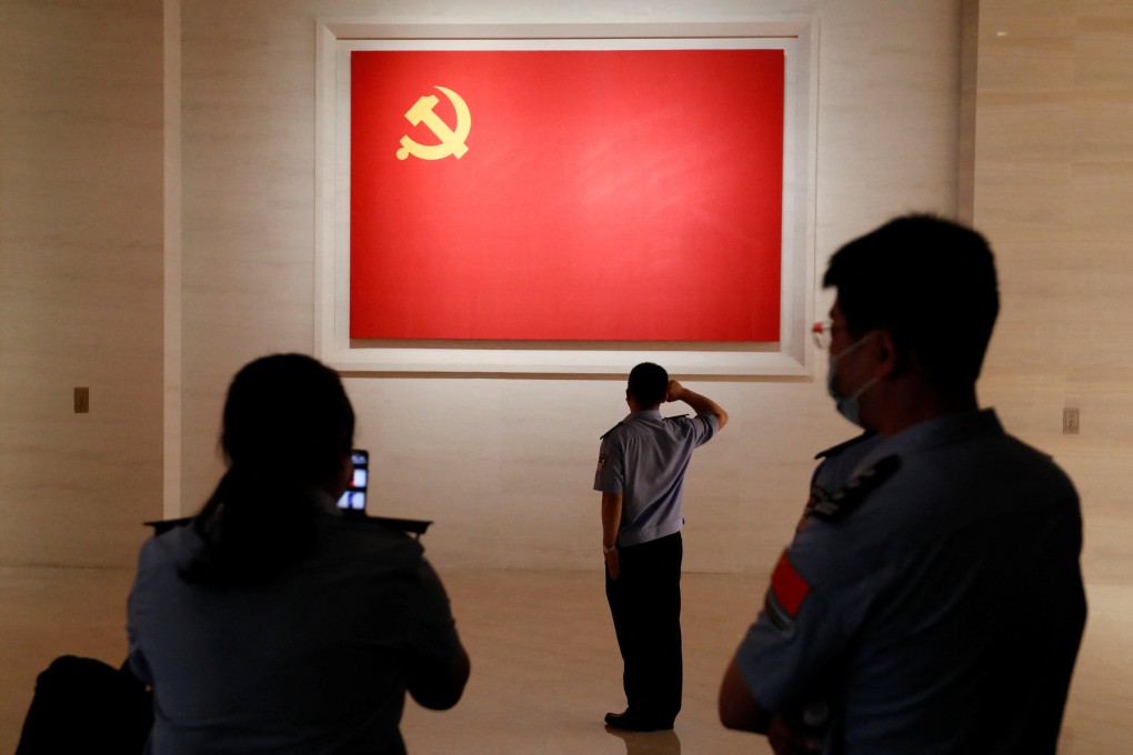A police officer poses in front of a Communist Party flag at the Museum of the Communist Party of China in Beijing. Party cadres have been issued a new set of rules intended to ensure loyalty to President Xi Jinping. Photo: Reuters