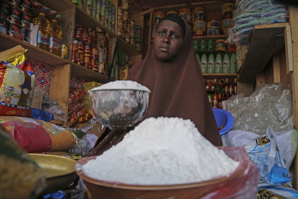 A shopkeeper sells wheat flour at a market in Mogadishu, Somalia. Photo: AP
