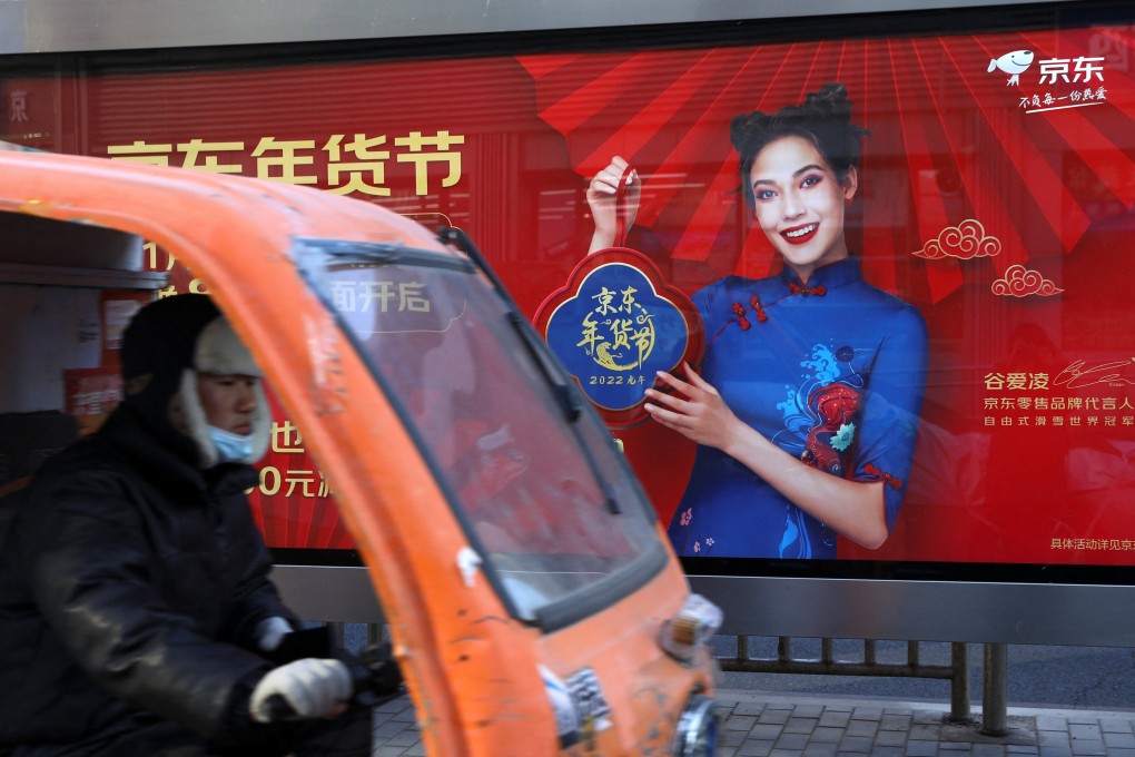 A delivery truck drives past a JD.com advertisement with an image of freestyle skier Eileen Gu, in Beijing, January 11, 2022. Ad budgets have been slashed amid economic headwinds. Photo: Reuters