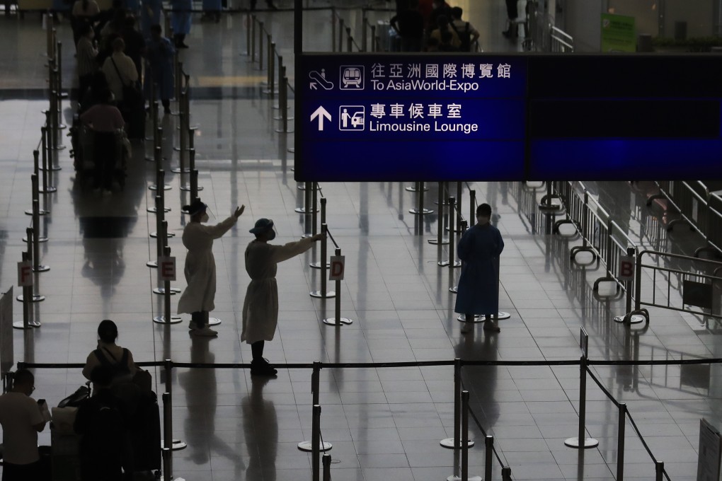 Staff beckon to arriving passengers at Hong Kong’s airport. The city has been mostly closed off to the world for more than two years. Photo: Xiaomei Chen