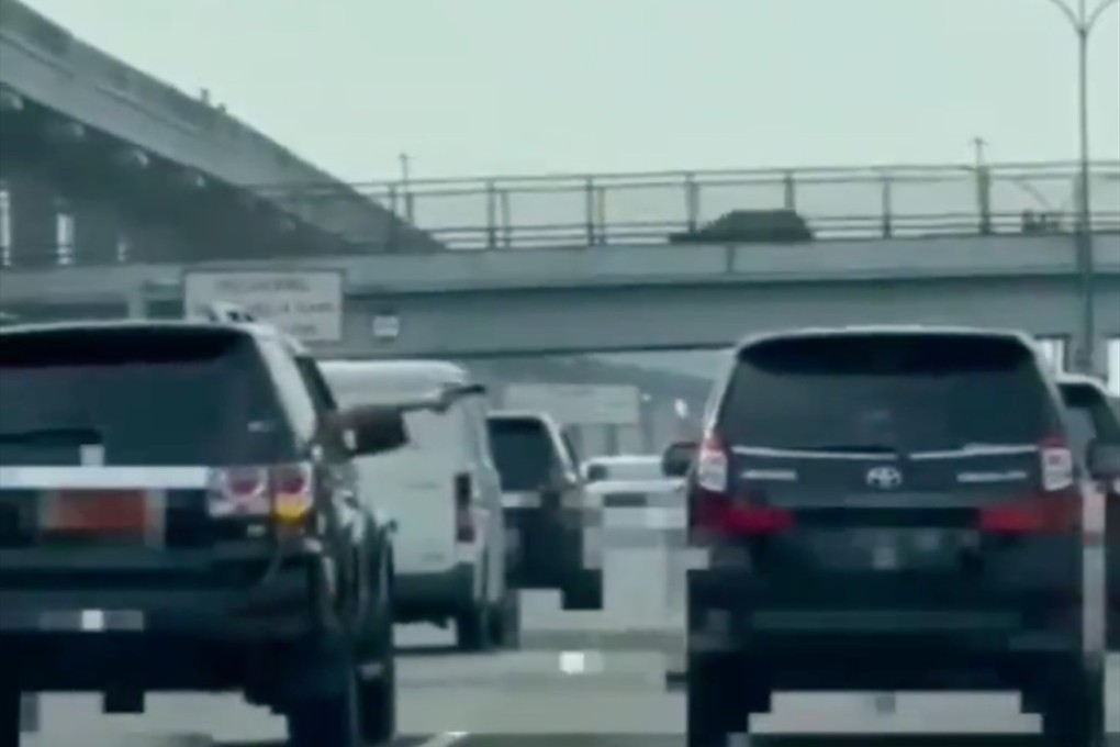 An Indonesian military captain has come under fire for pointing a gun at another car while driving a government-issued vehicle on the Jagorawi toll road in West Java. Photo: Twitter @InfoJakarta