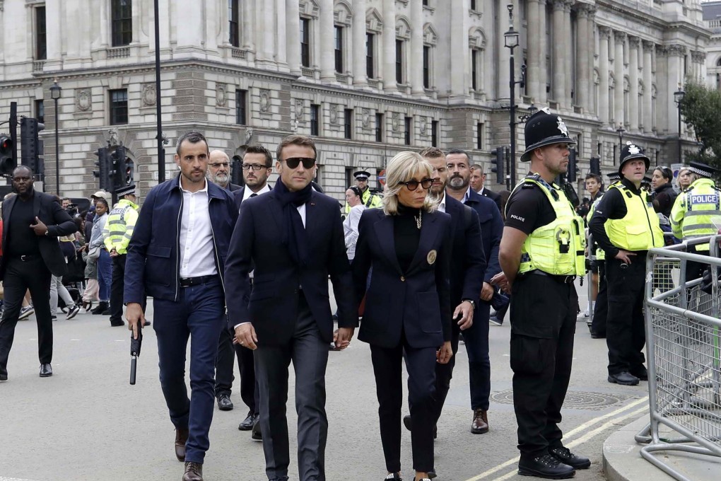 French President Emmanuel Macron (centre left) and his wife Brigitte Macron arrive at Westminster Hall to pay their respects to Britain’s late Queen Elizabeth II.  Photo: EPA-EFE/Olivier Hoslet