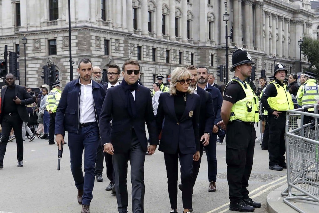 French President Emmanuel Macron (centre left) and his wife Brigitte Macron arrive at Westminster Hall to pay their respects to Britain’s late Queen Elizabeth II. Photo: EPA-EFE/Olivier Hoslet