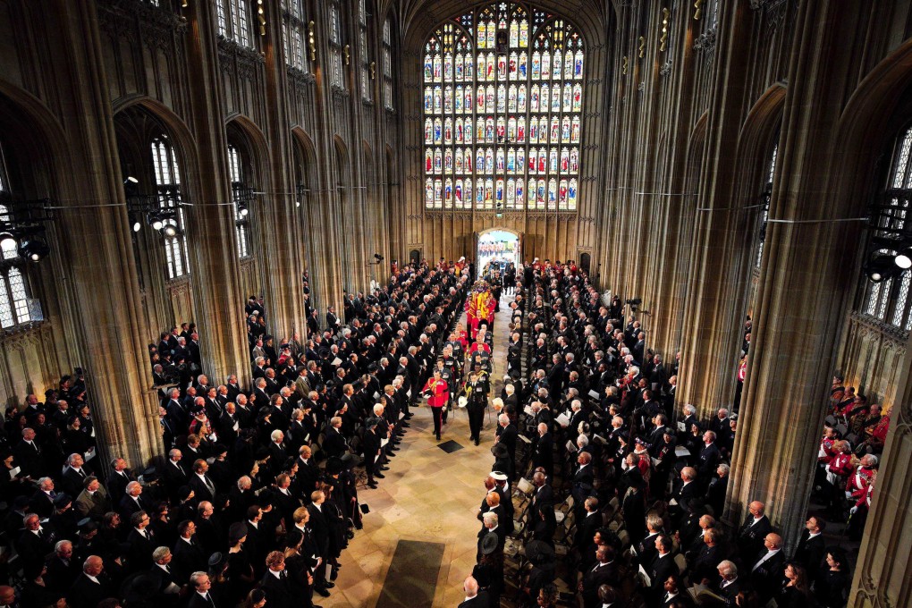 Pall bearers carry the coffin of Queen Elizabeth II past mourners into St. George’s Chapel at Windsor Castle on Monday. Photo: AFP