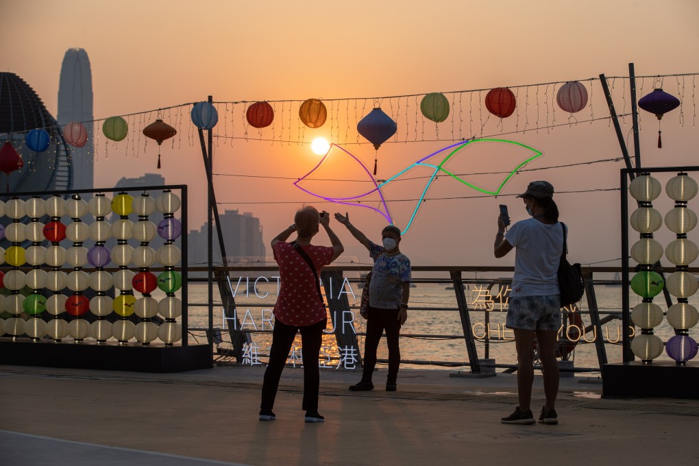 People take photos in a park next to Victoria Harbour in Hong Kong on September 13, 2022, a day when air pollution in some parts of Hong Kong reached ‘serious’, the highest health risk level, according the air quality health index operated by the Environmental Protection Department. Photo: EPA-EFE