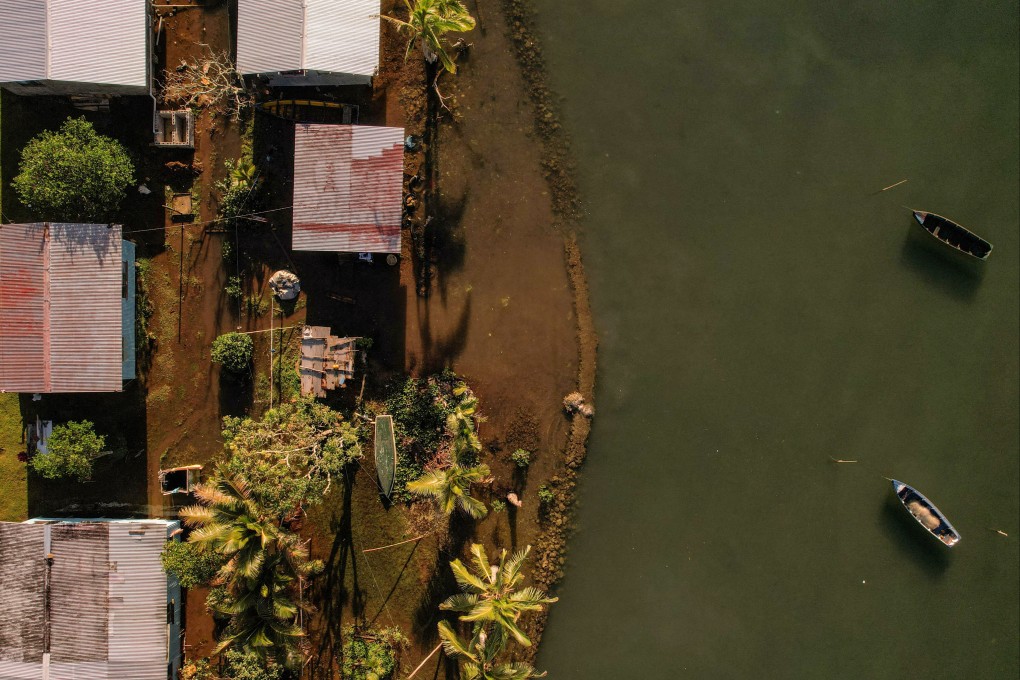 Seawater floods past an ineffective sea wall into Veivatuloa village in Fiji on July 16. Leaders of 15 low-lying Pacific island nations declared climate change their “single greatest existential threat” at a summit in Fiji’s capital, Suva. Photo: Reuters