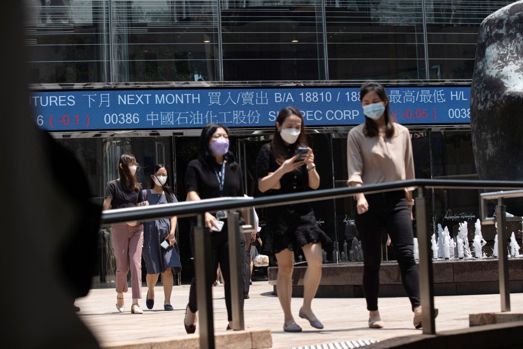 People walk past Exchange Square,, the building housing the stock market in Hong Kong, on September 14, 2022. Photo: EPA-EFE