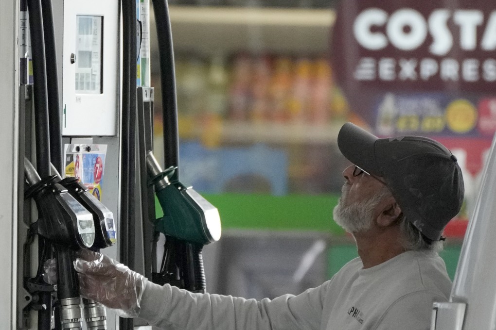 A motorist checks a petrol pump at a filling station in London, on June 9. Britain’s new Prime Minister Liz Truss has pledged to rebuild an ailing economy, on the brink of a potentially long recession, with record inflation and millions in need of government help to cope with energy bills. Photo: AP