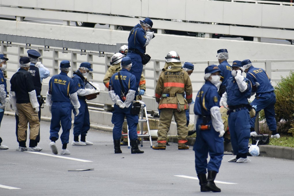 Police officers and firefighters investigate the site where a man who was protesting a state funeral for former Japanese Prime Minister Shinzo Abe set himself on fire, near Prime Minster Fumio Kishida’s official residence in Tokyo, on Wednesday. Photo: Kyodo via Reuters