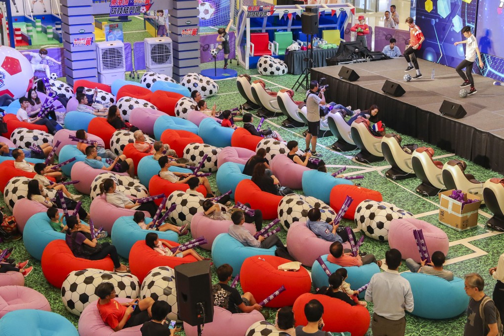 Fans watch a live broadcast of the opening match of the 2018 Fifa World Cup at an event held at East Point City in Tseung Kwan O on June 14, 2018. Now TV, the World Cup broadcast rights holder in Hong Kong, has drawn criticism for its steep prices for the 2018 and 2022 World Cup packages. Photo: K Y. Cheng
