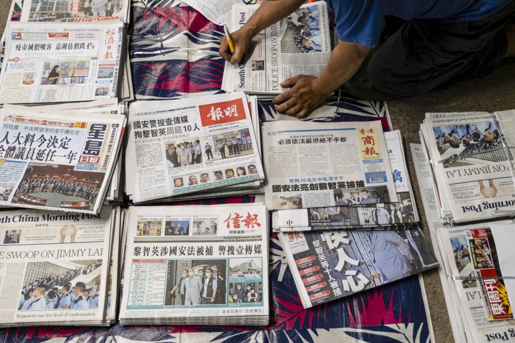 A vendor arranges newspapers for distribution. Hong Kong’s leader has urged journalists to stay away from ‘camouflaged media’ and bad apples in the industry. Photo: Bloomberg