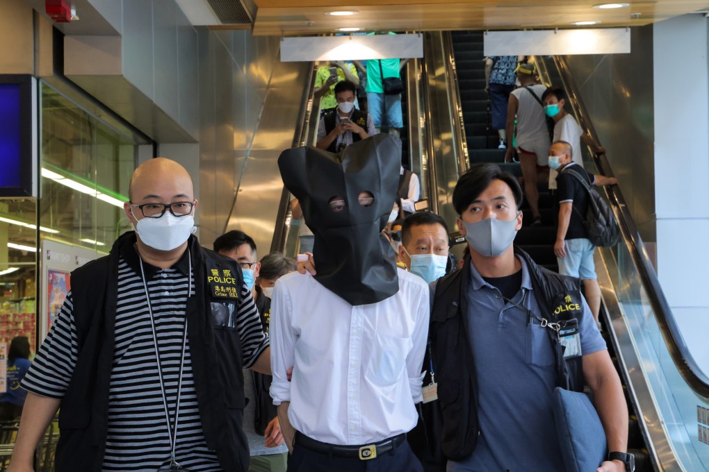 Police escort a suspect from a clinic in Chai Wan. Photo: Jelly Tse