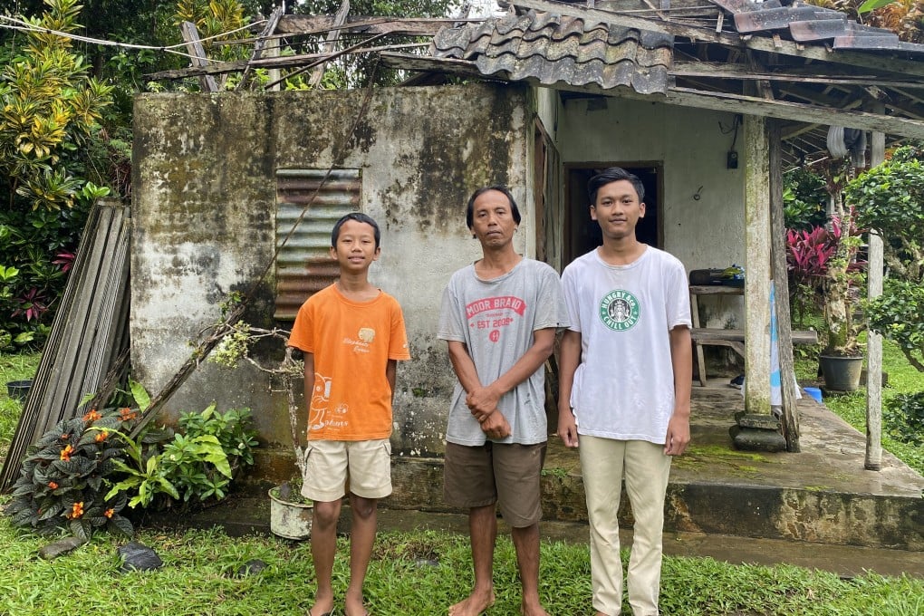 I Made Nuka (centre) struggles to send his youngest child to middle school as prices of basic goods and fuel are rising, limiting his job opportunities as a construction worker. Photo: SCMP / Resty Woro Yuniar