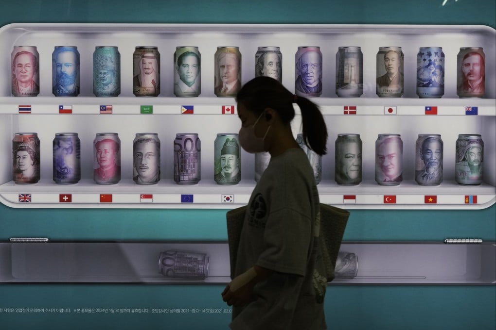 A woman passes a bank currency advertisement in Seoul, South Korea, on September 23. Photo: AP