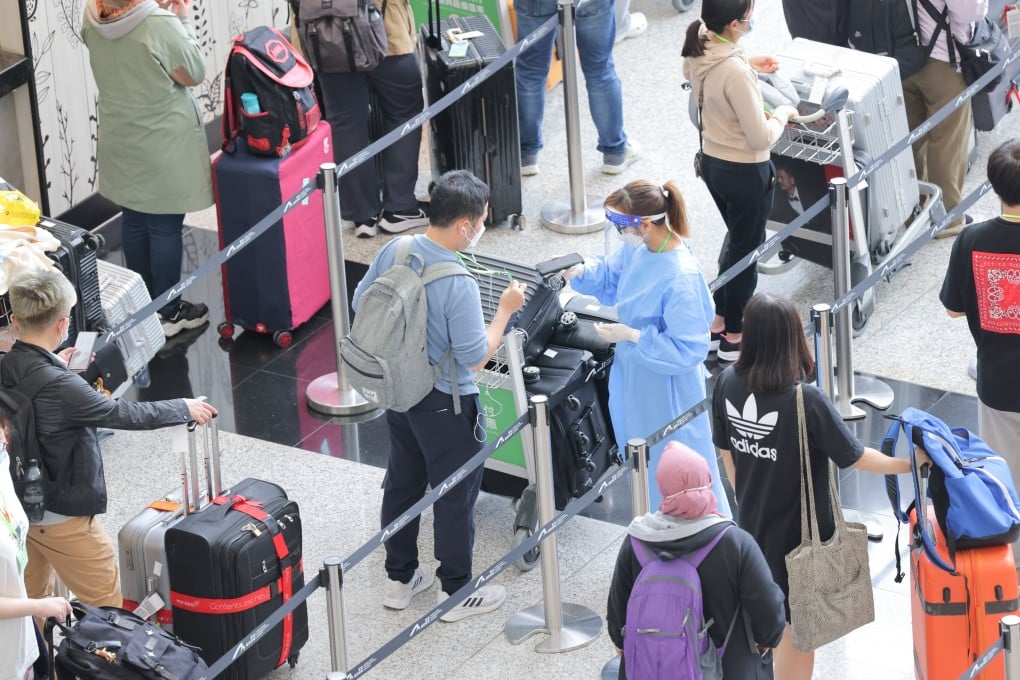 Passengers line up in an area for quarantine processing, in the arrivals hall at the Hong Kong International Airport. Photo: Jelly Tse