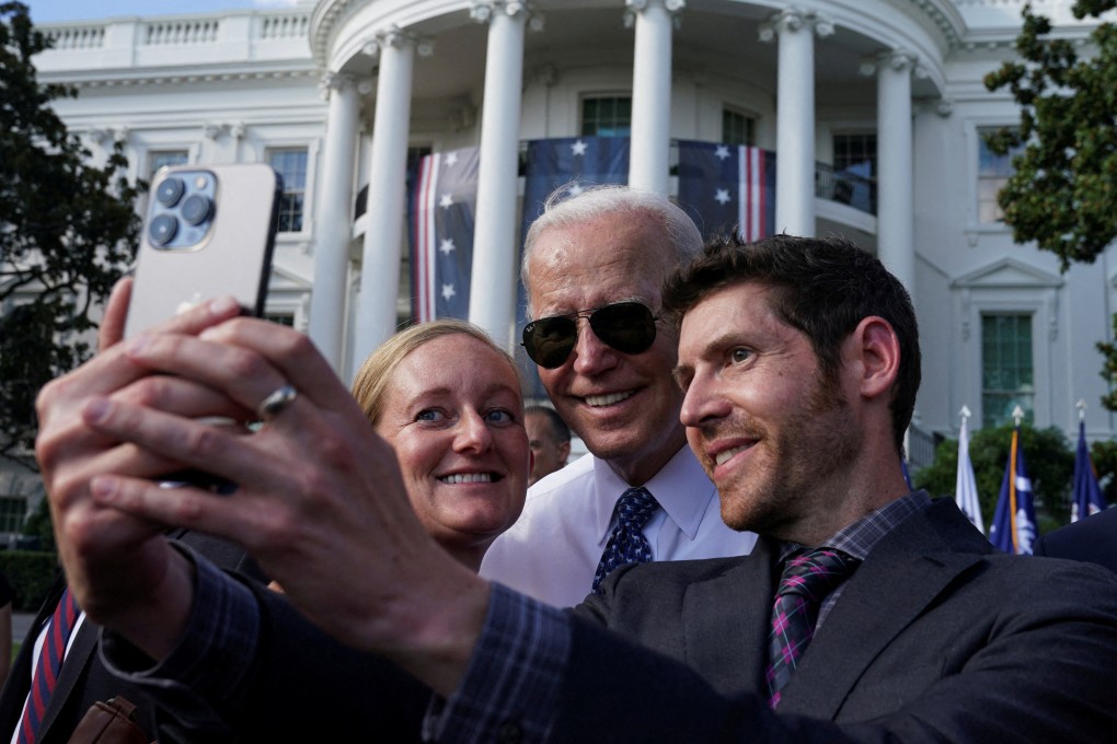 US President Joe Biden posing for a selfie with guests at the White House on September 13. Photo: Reuters