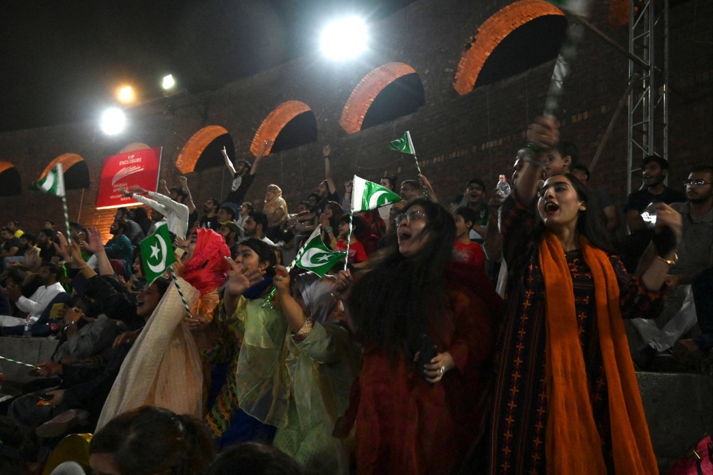 Fans cheer while watching the live telecast of the Asia Cup T20 cricket match between India and Pakistan in Dubai, on big screens in Lahore on August 28. Photo: AFP