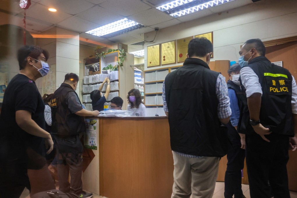 Police officers investigate one of the three clinics involved in Thursday’s arrests.  Photo: Jelly Tse