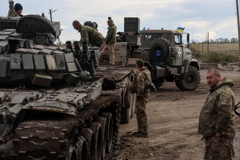 Ukrainian servicemen load a destroyed Russian tank at a truck, as Russia’s attack on Ukraine continues, in the town of Izium in Kharkiv region, Ukraine on Saturday. Photo: Reuters