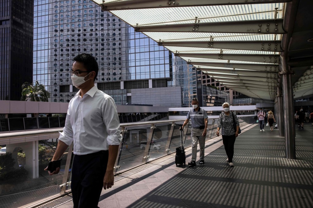 People walk across a footbridge in the Central business district of Hong Kong on September 15, 2022. Photo: AFP