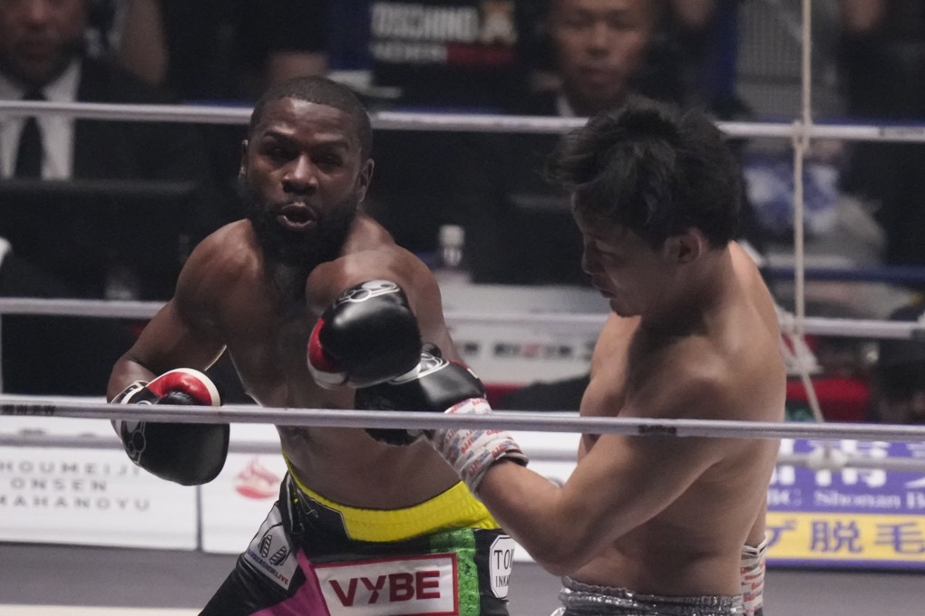 Boxer Floyd Mayweather of the US throws a punch against mixed martial artist Mikuru Asakura of Japan at the Super Rizin event in Saitama. Photo: AP