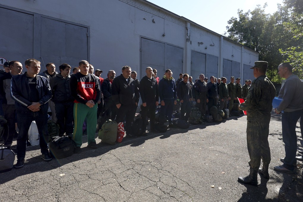 Russian men near a recruitment centre in Krasnodar, Russia on Sunday. Photo: AP