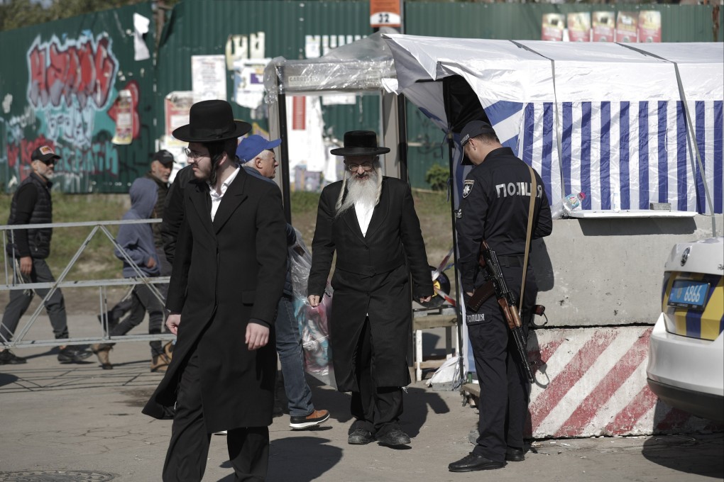 Ultra-orthodox Jewish pilgrims pass a security checkpoint on their way to pray next to  the tomb of Rabbi Nachman ahead of Rosh Hashanah in Uman, Ukraine on Sunday. Photo: EPA-EFE