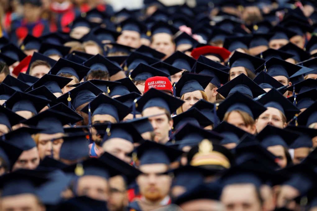 A graduate wears a “Make America Great Again” hat amidst a sea of mortar boards before the start of commencement exercises at Liberty University in Lynchburg, Virginia, in 2019. Photo: Reuters