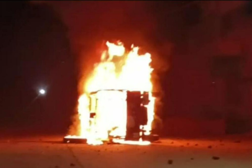A police vehicle is set on fire after protests break out over a Dalit boy’s death. Photo: Twitter