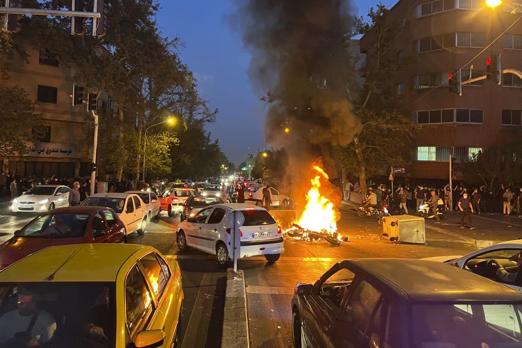 A police motorcycle burns during a protest over the death of Mahsa Amin in downtown Tehran, Iran, on September 19. Photo: AP