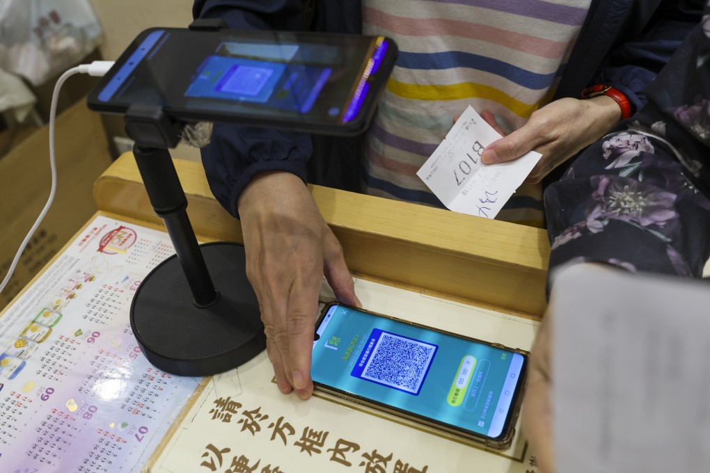 A customer scans the ‘Leave Home Safe’ app before entering a restaurant. Photo: Yik Yeung-man