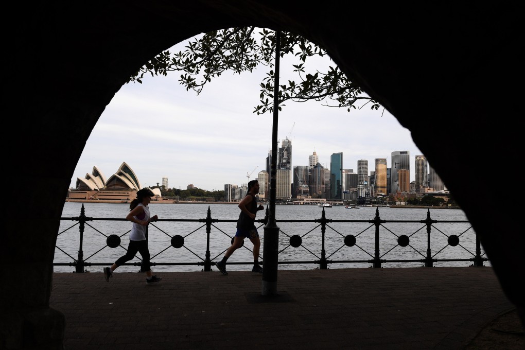 People jog in view of the skyline in Sydney, Australia on September 2, 2020. Photo: EPA-EFE