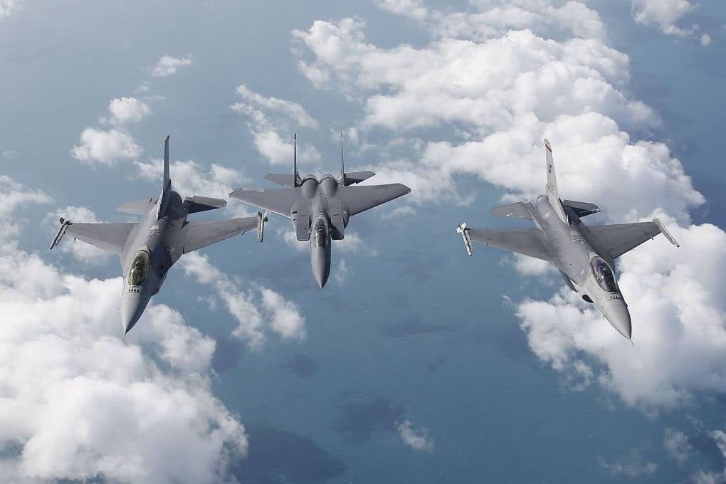 Two Republic of Singapore Air Force F-16s flank a F-15SG fighter jet while flying in formation over the South China Sea in a 2018 file photo. Photo: EPA-EFE