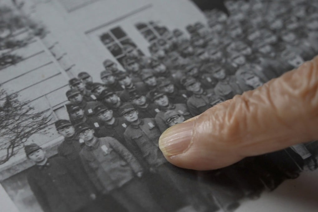 Shigeru Imaizumi, a 96-year old graduate of Kenkoku University, points to himself in a school photo. Photo: Kenkoku University via AP