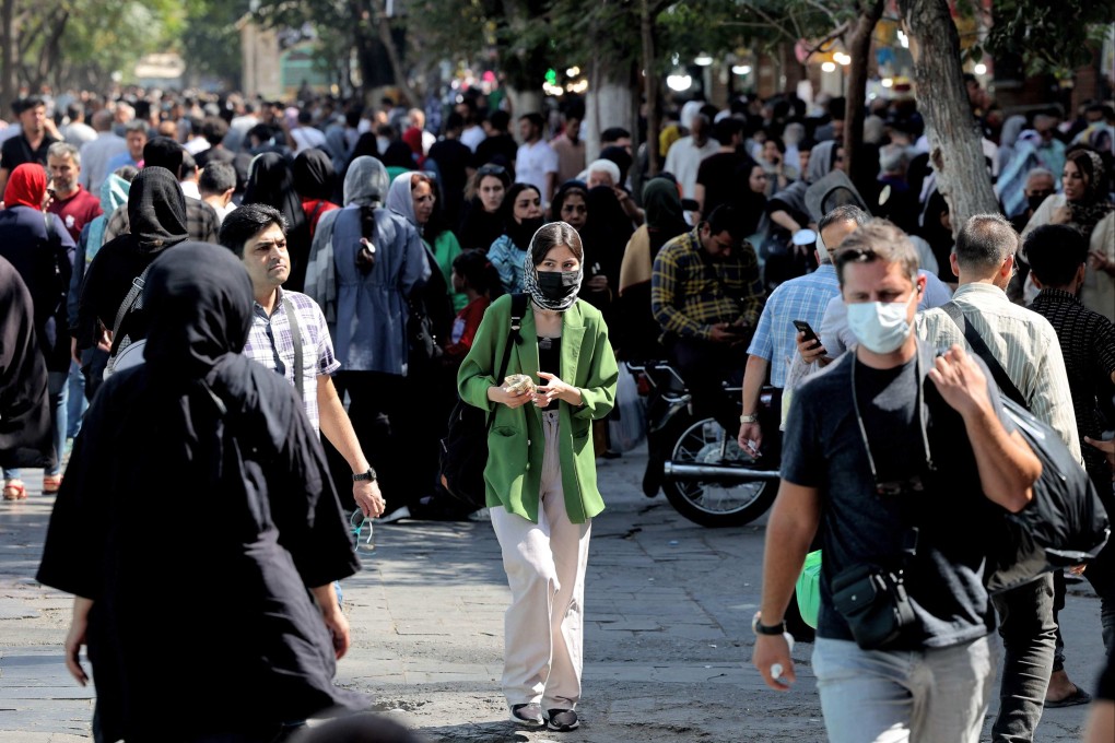 A woman walks with other shoppers at the Grand Bazaar in Iran’s capital Tehran on September 28. Iran’s police have warned that they will confront “with all their might” women-led protests that erupted nearly two weeks ago over the death of Mahsa Amini in custody. Photo: AFP