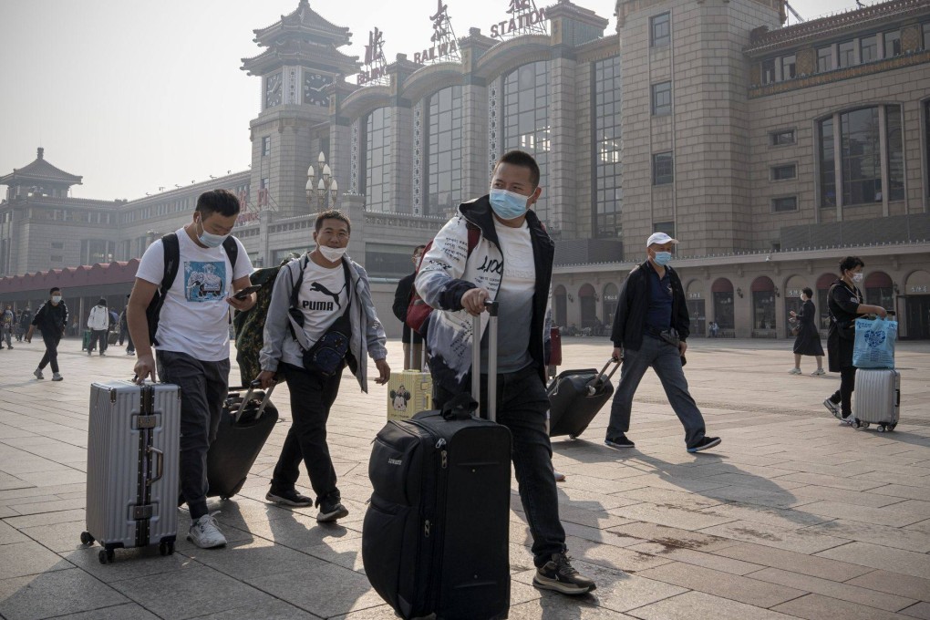 Travellers outside the Beijing Railway Station on Tuesday. Chinese have been urged to stay put during the “golden week” holiday. Photo: Bloomberg