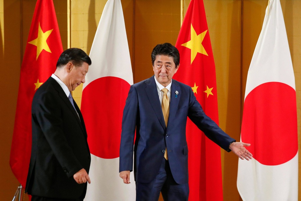 Chinese President Xi Jinping (left) is escorted by then Japanese prime minister Shinzo Abe at the start of their talks in Osaka on June 27, 2019, ahead of the G20 summit. Photo: AFP