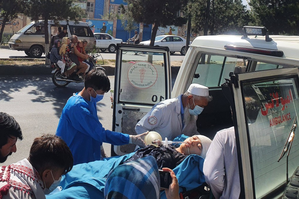Medical staff with a wounded girl in Kabul, Afghanistan on Friday, following a fatal blast at an education centre. Photo: AFP