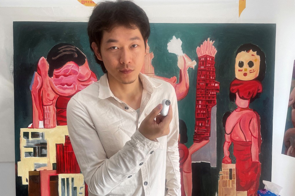 Artist Siyuan Zhuji with the camera he uses to film his regular Covid-19 tests, at his studio in Jiangsu province, eastern China. Photo: Reuters