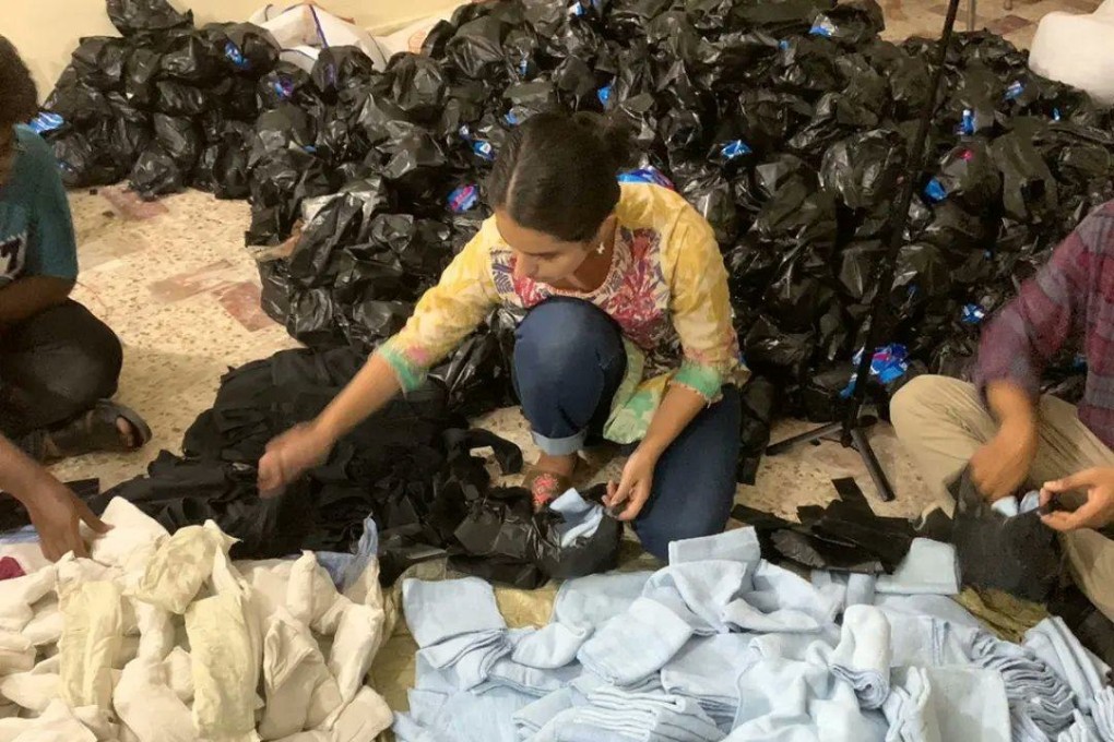 Student Bushra Mahnoor packs supplies for menstruating women and girls caught up in Pakistan’s floods. Menstruation is a taboo topic in the country. Photo: Mahwari Justice