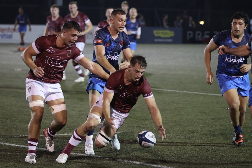Kowloon’s Eliott Quinton picks up the ball against HIK Scottish at King’s Park in Yau Ma Tei. Photos: Jonathan Wong