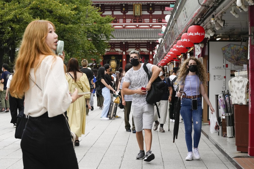 Foreign tourists walk through Nakamise Street at Asakusa, in downtown Tokyo. Photo: EPA-EFE