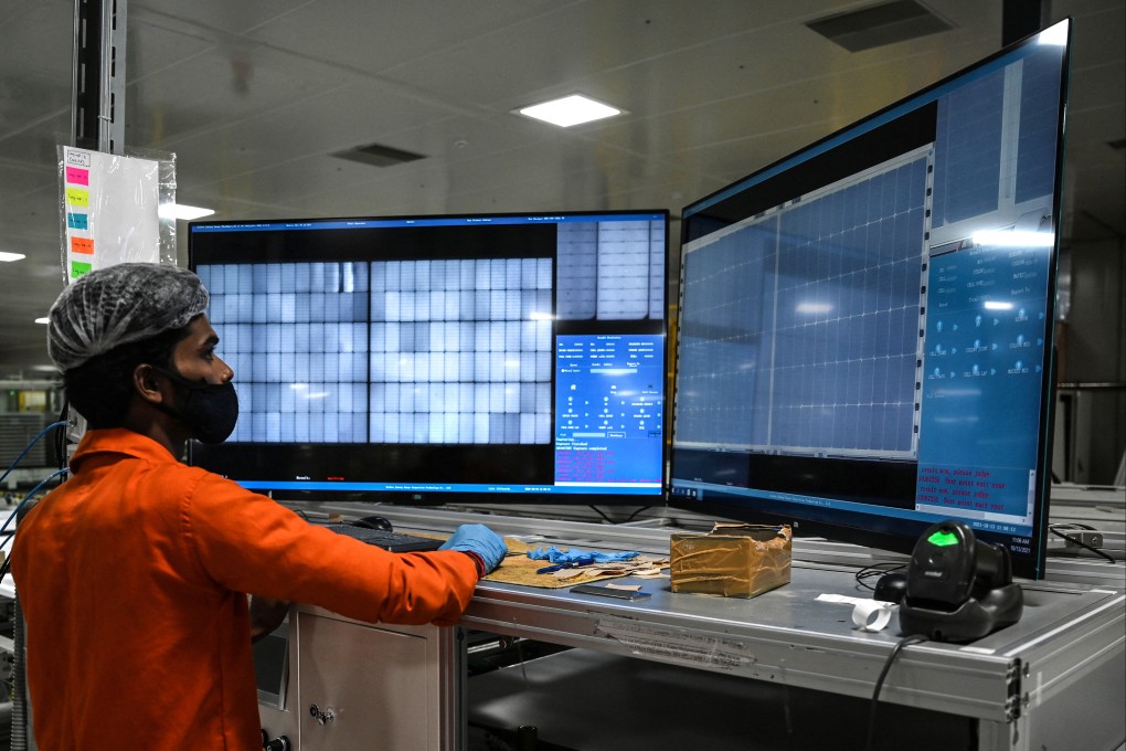 An employee examines solar cells before lamination process at the Vikram Solar manufacturing plant in Oragadam, in the southern Indian state of Tamil Nadu. Photo: AFP