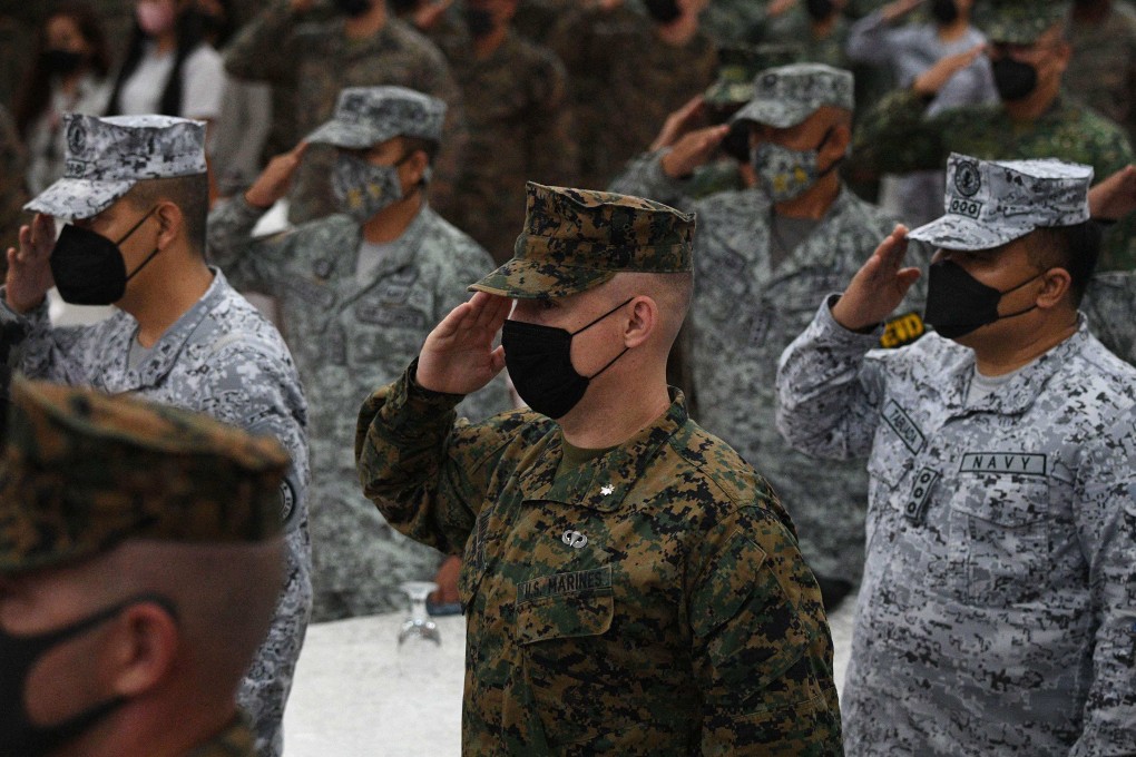 Philippine and US marines salute while their national anthems are played during the opening ceremony of “Kamandag” , a joint military exercise between US and Philippine marines on Monday. Photo: AFP