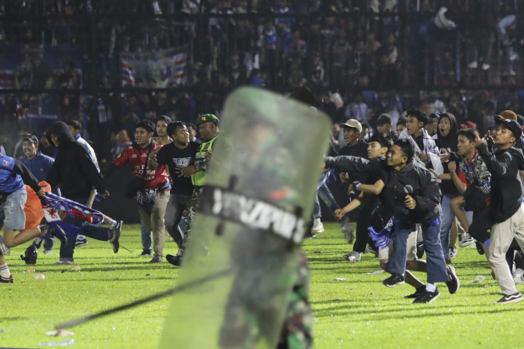 Fans enter the pitch during a clash between supporters at Kanjuruhan Stadium in Malang, East Java, Indonesia on October 1, 2022. Photo: AP