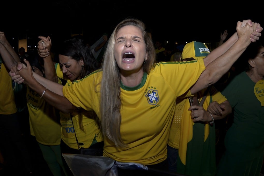 Supporters of Brazilian President Jair Bolsonaro, who is running for another term, pray as they wait for the results in Brasilia, Brazil. Photo: AP