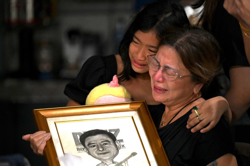 Family members grieve the loss of journalist Percival Mabasa at their home in Las Pinas, Manila. Photo: AFP